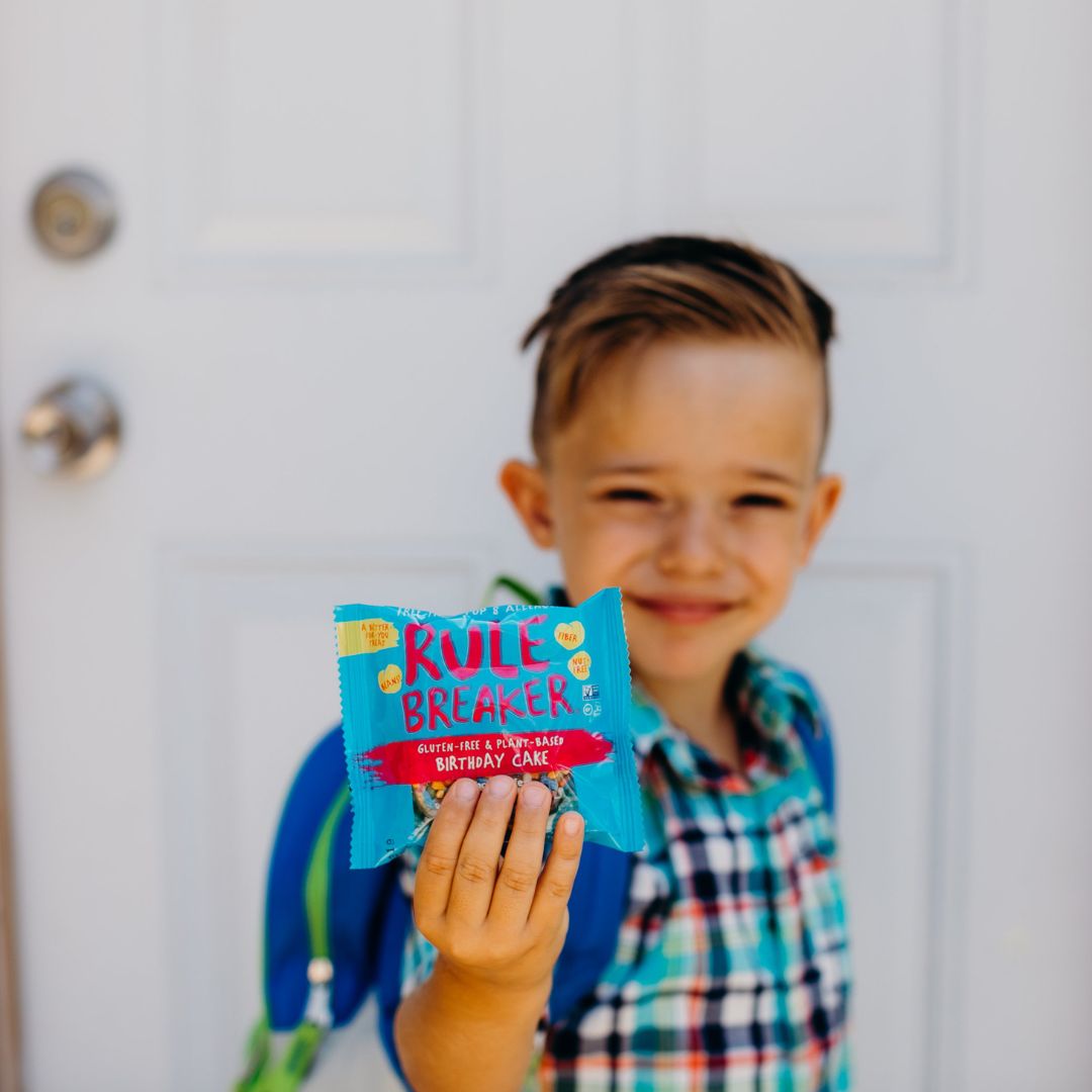 Rule Breaker Snacks Birthday Cake Singles child holding in front of him